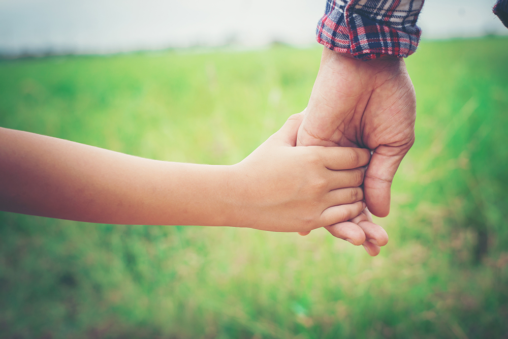 Close up of father holding his daughter hand, so sweet,family ti